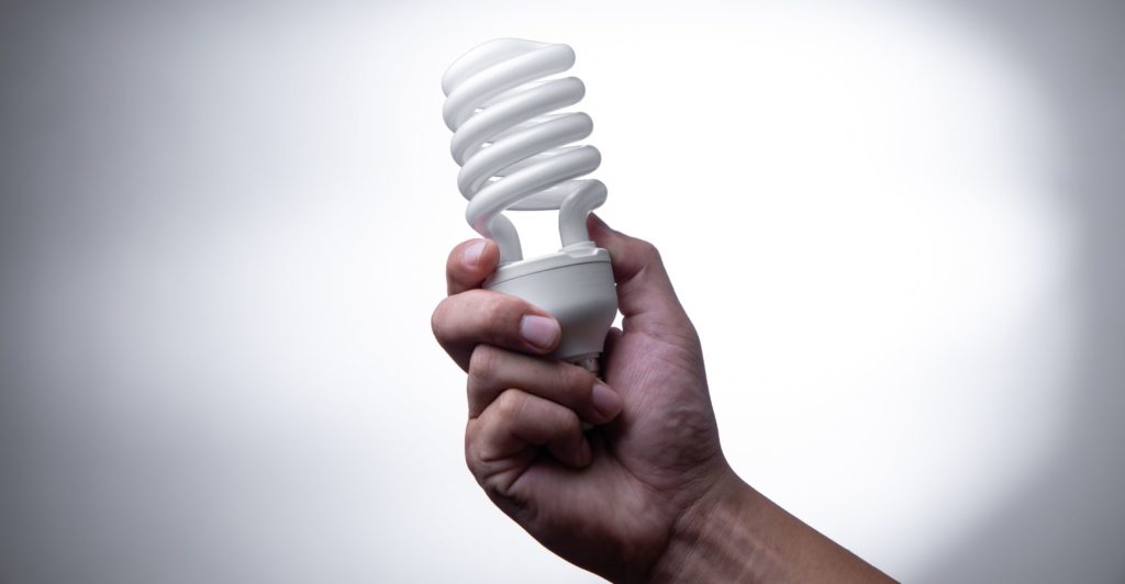 energy saving lightbulb in hand