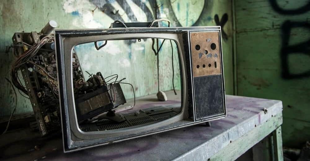 broken disasembled vintave TV on table