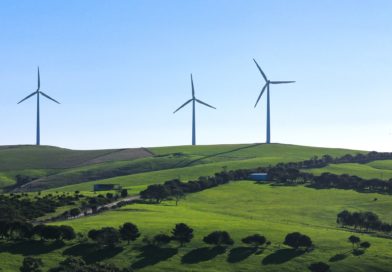 Wind turbine energy system on green hills